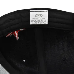 Macro view of inner label and red star embroidery on black 100% cotton baseball cap
