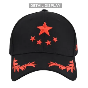 Close-up of red star and wheat embroidery details on a black cotton baseball cap