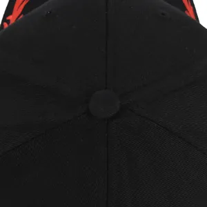 Macro shot of black baseball cap top button and detailed red flame embroidery stitches