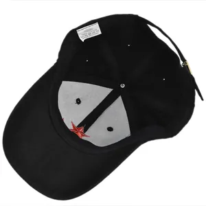 Detail of internal black cotton cap structure with 100% cotton tag and red star embroidery