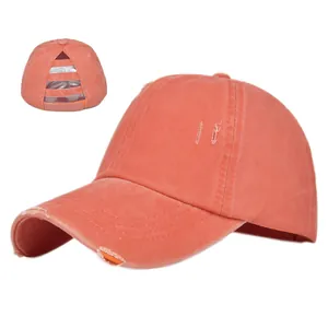 Detail of coral ponytail baseball cap with distressed finish and elastic back openings
