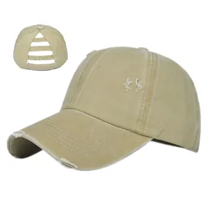 Detail of khaki ponytail baseball cap showing elastic cross bands and frayed edges
