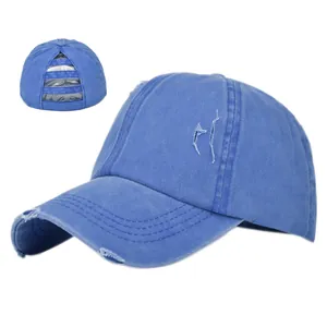 Detail of royal blue washed ponytail baseball cap showing elastic criss-cross back design