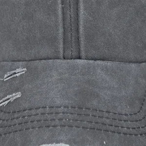 Detailed view of the distressed washed cotton brim and stitching on this ponytail cap