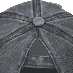 Detail view of the ponytail hole and stitching on a vintage washed grey baseball cap