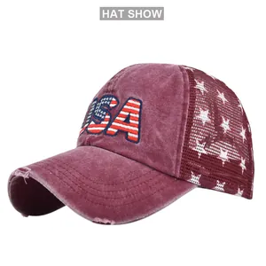 Detailed macro view of embroidered USA lettering and distressed brim on mesh baseball cap