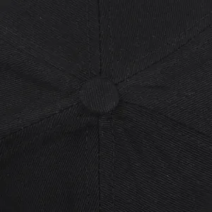 Macro-opname van de bovenste knoop en zesstaps stiksels op deze zwarte katoenen twill pet