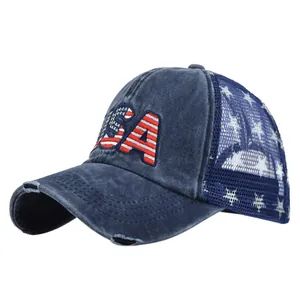 Detail of embroidered USA letters with star pattern on navy blue mesh trucker cap
