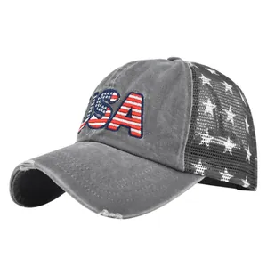 Detailed macro view of embroidered USA text and distressed grey wash cotton on the cap brim