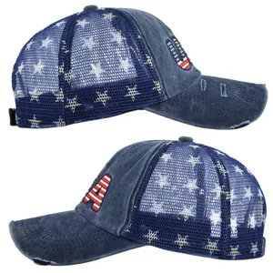 Detailed close-up showing embroidered USA letters and star mesh on navy trucker cap