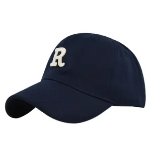 Detail view of the navy blue baseball cap featuring white 3D letter R embroidery