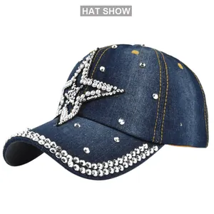 Detailed view of denim baseball cap with rhinestone star pattern and studded brim edge