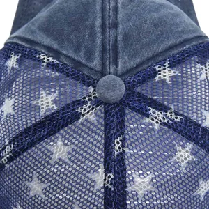 Close-up of vintage blue trucker hat featuring white stars pattern on navy mesh material