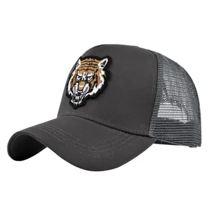 Detailed embroidery of a colorful tiger head on a dark grey mesh trucker baseball cap