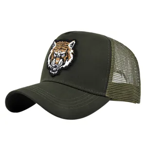 Close-up of a premium tiger head embroidery on a green mesh trucker baseball cap