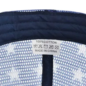 Detail shot of navy blue baseball cap interior showing 100% cotton label and mesh fabric