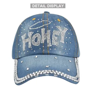 Detail shot of blue denim baseball cap with HONEY rhinestone letters and yellow stitching