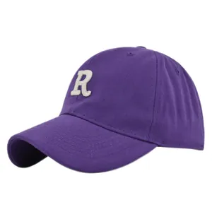 Detailed view of the white 3D letter R embroidery on a premium purple cotton baseball cap
