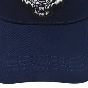 Detailed close-up of tiger head embroidery on a navy blue cotton baseball cap
