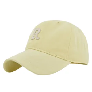 Close-up of premium 3D white R letter embroidery on beige cotton twill baseball cap