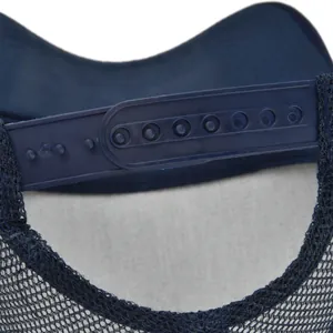 Detail of adjustable navy blue snapback closure and breathable mesh on baseball cap