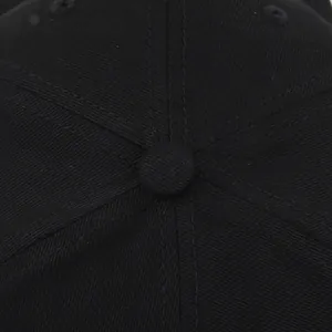 Close-up of the black twill fabric baseball cap crown with stitched panels and top button