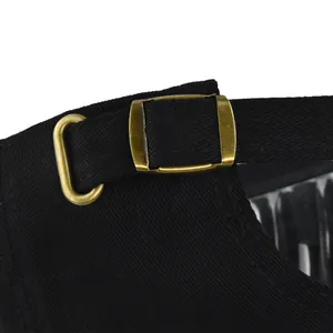 Close-up of the black twill baseball cap's adjustable strap with a vintage bronze metal buckle