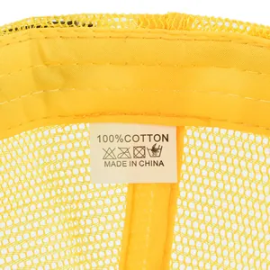 Detail of the cotton sweatband and care label inside a yellow mesh trucker baseball cap
