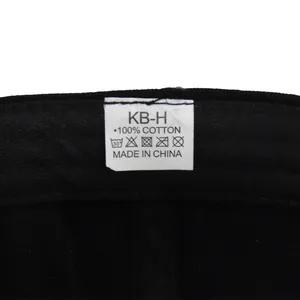Detail showing the internal 100% cotton material tag and quality stitching on the black cap