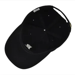 Inside view of black cotton baseball cap showing 100% cotton label and metal buckle