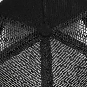 Macro view of the black mesh trucker hat showing top button and breathable fabric detail