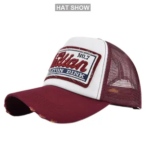 Close-up of distressed vintage trucker hat with burgundy mesh and embroidery detail
