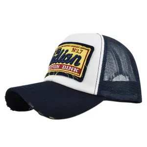 Detail of vintage trucker hat featuring 3D embroidery patch and distressed brim mesh
