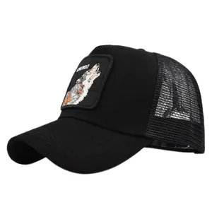 Detail of black mesh trucker hat with Lone Wolf animal embroidery patch and curved brim