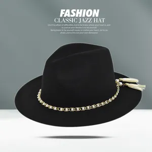 Detailed macro view of black wool fedora featuring gold chain, pearls, and yellow tassels