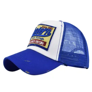 Detail of vintage Western trucker hat with blue mesh, embroidery and distressed brim