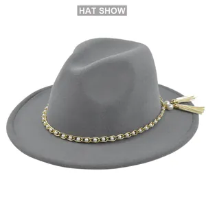 Detail of dark grey fedora with gold chain, white pearls and cream tassels decoration