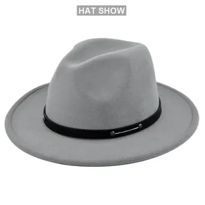 Macro detail of grey wool fedora hat with black decorative band and metal studs