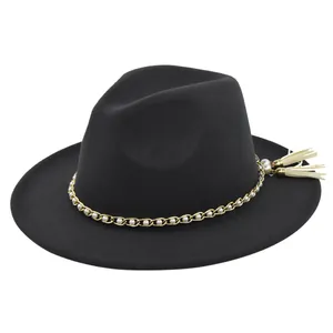 Close-up of black wool fedora featuring gold chain, white pearls, and elegant side tassels