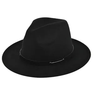 Detail of black fedora with leather band, metal studs and white stitching on wool felt