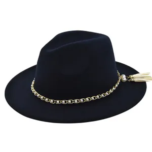 Detail of black fedora hat featuring gold chain with pearls and elegant double tassels