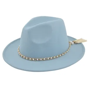 Detail of light blue wool jazz hat featuring gold pearl chain and white tassel charm
