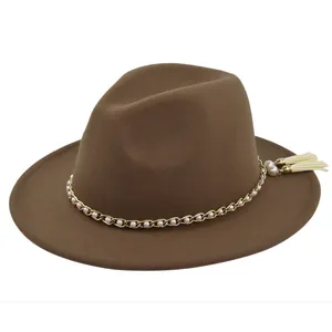 Detail of brown wool fedora featuring gold chain link with white pearls and side tassels