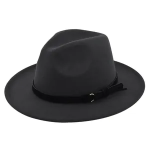 Detail of dark grey wool fedora hat with black belt band and gold metal ring accent