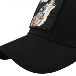 Close-up of wolf head embroidery and LONE WOLF patch on a black mesh trucker hat
