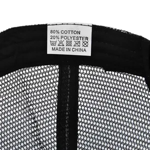 Detail view of cotton-polyester blend fabric and wash tag inside the mesh trucker cap
