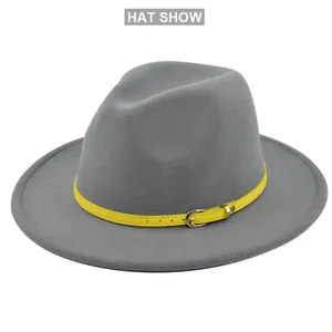 Detailed shot of gray fedora hat featuring a contrasting yellow buckled decorative strap