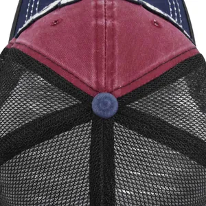 Macro detail of wine red cotton crown with breathable black mesh and white stitching