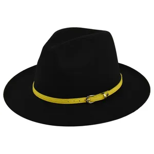 Detail of black wool fedora featuring a vibrant yellow leather strap with silver buckle