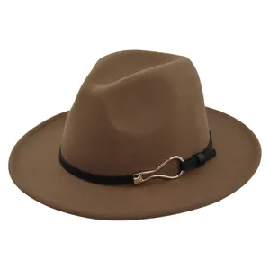 Detail of a brown wool felt fedora featuring a black leather belt with a gold horseshoe buckle